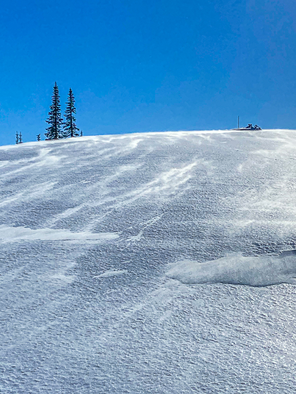 Wind blowning snow on scoured slope.