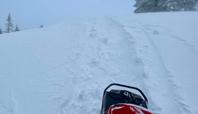 Cracking in the snow surface shooting out from the snowmobile where the wind was stiffining the surface or actively building a slab.